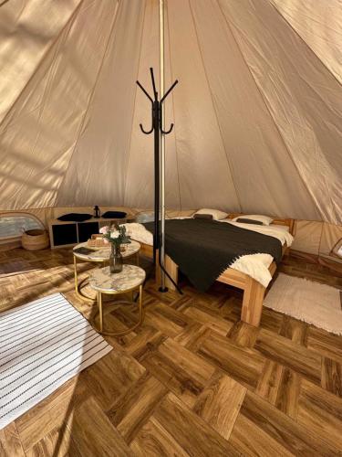 a bedroom with a bed in a tent at Brzozowisko Tuchomko - Glamping in Tuchomie