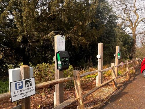 a parking meter next to a fence with a sign at Ockenden Manor Hotel & Spa in Cuckfield