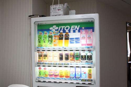 a refrigerator filled with lots of sodas and drinks at Grampus Inn Osaka in Osaka