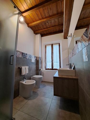 a bathroom with two toilets and a sink at La Locanda nel Frutteto in Rovereto