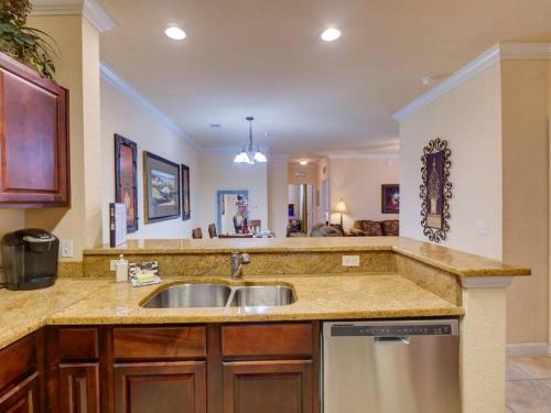 a kitchen with a sink and a counter top at Disney Memories at Tuscana Resort in Kissimmee