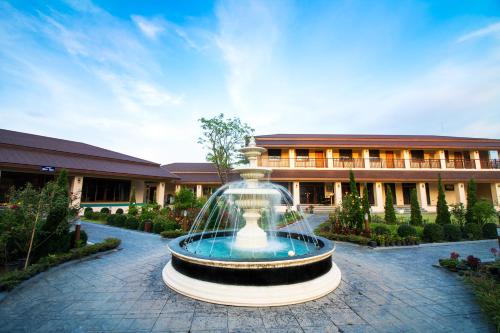 a large fountain in front of a building at AU Place Hotel in Loei