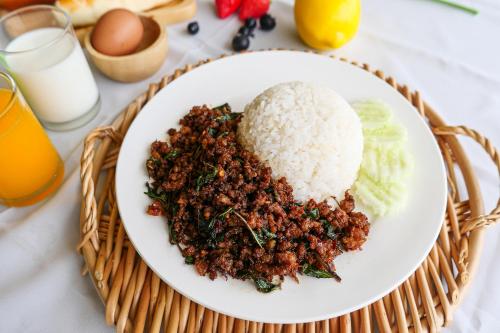 a plate of food with rice and vegetables at AU Place Hotel in Loei