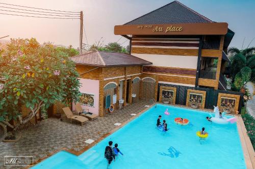a group of people in a pool in a house at AU Place Hotel in Loei