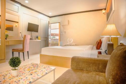 a hotel room with a bed and a couch at AU Place Hotel in Loei