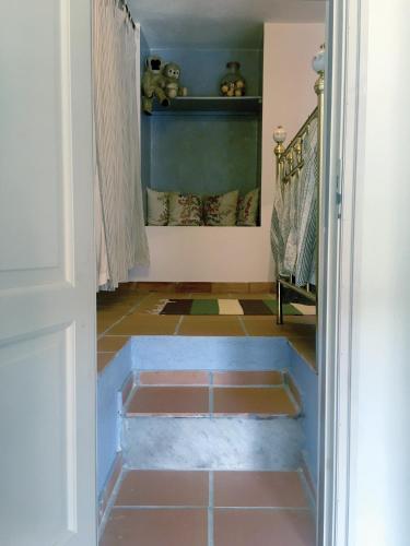aoyer with a door open to a bathroom with a tile floor at Experience the Provençal dream in Taradeau