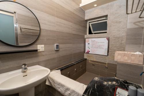 a bathroom with a sink and a mirror at 沐-湯宿溫泉行旅 in Jiaoxi