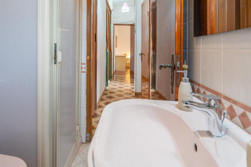 a bathroom with a white sink and a hallway at Fortezza Villa Azzurra in Agnone Bagni