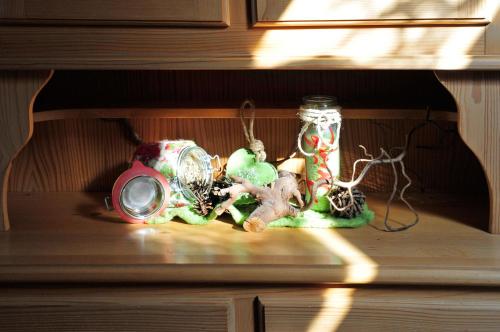 a shelf with a glass jar filled with christmas decorations at Ferienwohnungen Wendelstein in Bad Feilnbach