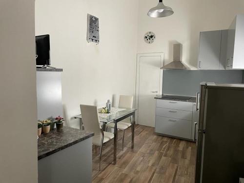 a kitchen with a table and chairs and a refrigerator at Al vecchio Mulino in Lastra a Signa