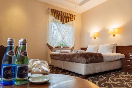 Hotel Dwór Choiny في Kazimierzówka: غرفة في الفندق مع أريكة وسرير