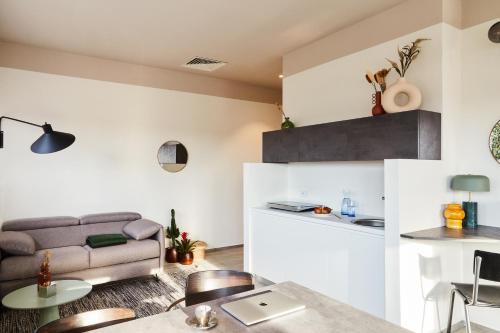 a living room with a couch and a table at MAR Modena Accommodation in Residence in Formigine