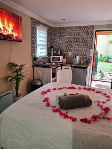 a bedroom with a bed with roses on it at Country Cabin in Midrand