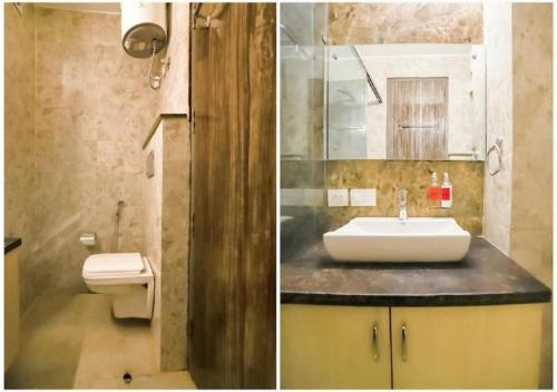 a bathroom with a sink and a toilet at Mavens Orange in Gurgaon