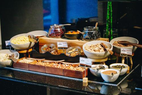 a buffet with different types of food on a table at Hotel Mona Plaza in Belgrade