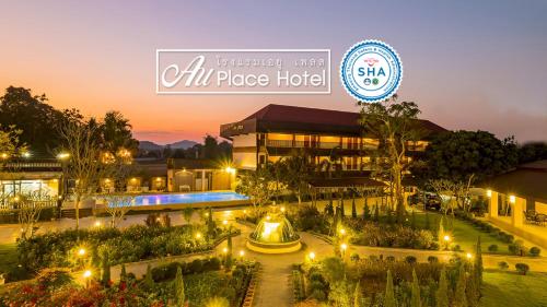 a building with a garden in front of it at night at AU Place Hotel in Loei