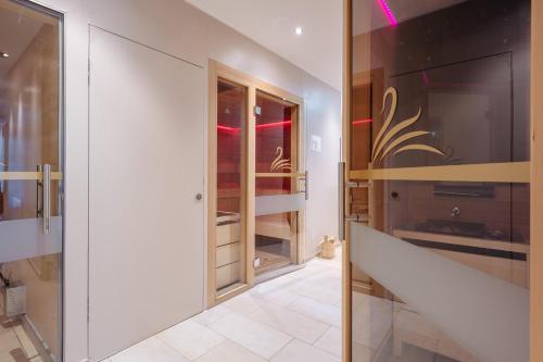 a room with a walk in closet with glass doors at Feel Good Apartments in Krumpendorf am Wörthersee