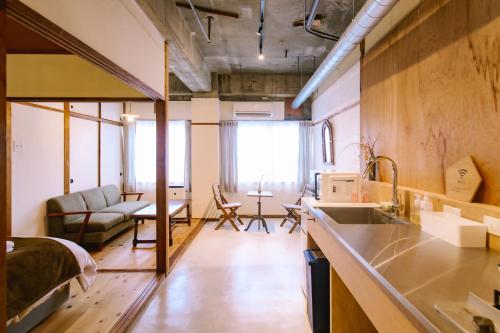 a room with a kitchen and a living room at Guesthouse RICO in Wakayama