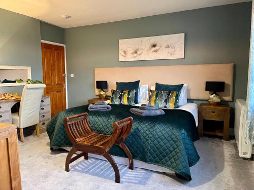 a bedroom with a green bed and a chair at New Wiggle Farmhouse in Millbrook