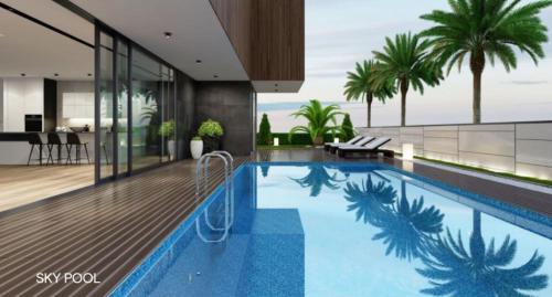 a swimming pool in a house with palm trees at Greenpark Bengaluru in Bangalore