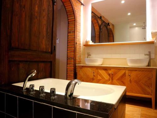 a bathroom with a sink and a mirror at Petite Dalat - Boutique Hotel in Da Lat