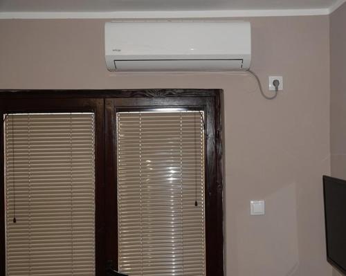 a ceiling fan and a window in a room at Pet Omorika in Bajina Bašta