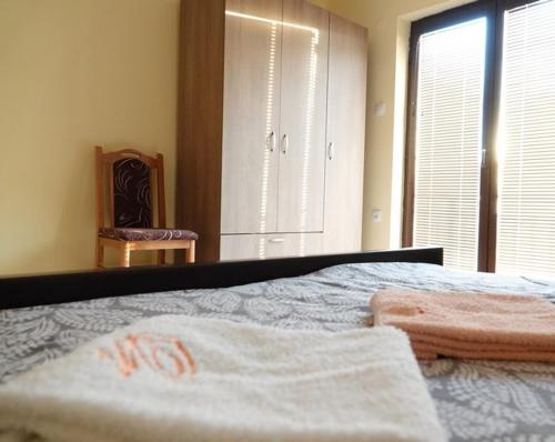 a bedroom with a bed with two towels on it at Pet Omorika in Bajina Bašta