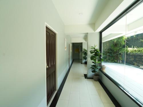 a hallway of a house with a large window at RoomQuest Bangkok Don Mueang Airport in Bangkok
