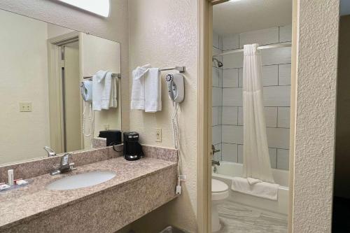 a bathroom with a sink and a toilet and a shower at Baymont by Wyndham Troy in Troy