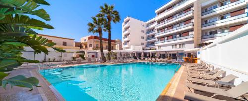 een zwembad met stoelen en een gebouw bij Best Western Plus Hotel Plaza in Rhodos-stad