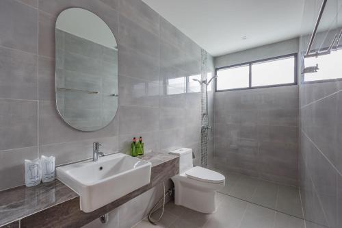 a bathroom with a sink and a toilet and a mirror at Vacay Aonang Hotel in Ao Nang Beach