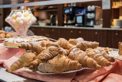 a bunch of croissants and other pastries on a table at Hotel Gardenia Sirmione in Sirmione