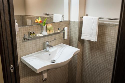 a bathroom with a white sink and a mirror at Hotel Gardenia Sirmione in Sirmione