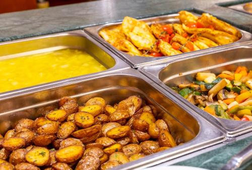 a tray of food with different types of food at Hotel Latini in Zell am See