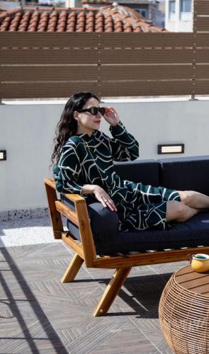a woman sitting in a chair on a couch at Athens Feeling in Athens