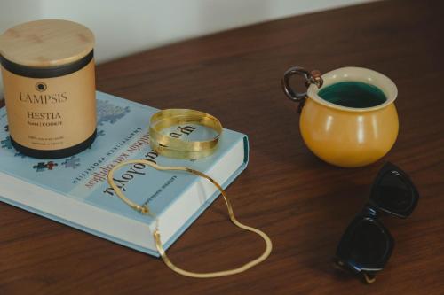 a book and a cup of coffee on a table at Athens Feeling in Athens