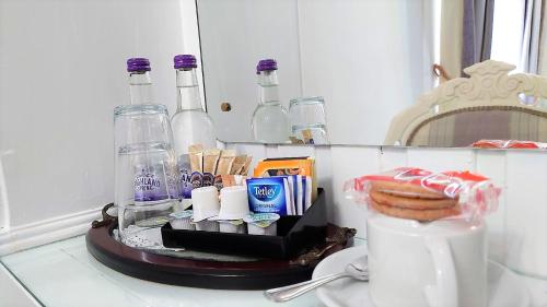 a counter with bottles of alcohol on a counter top at Heatherlie House Hotel in Selkirk
