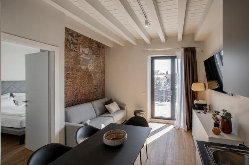 a living room with a couch and a table at Ah Villaglori Boutique Apartments in Brescia