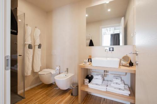 a bathroom with a sink and a toilet and a mirror at Ah Villaglori Boutique Apartments in Brescia