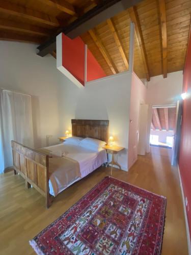 a bedroom with a large bed and a rug at Villa Dragoni in Buttrio