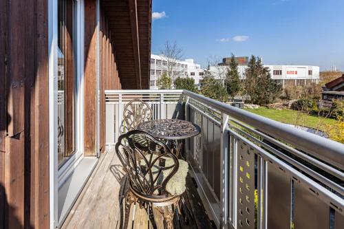 a balcony with a table and chairs on a balcony at Ülger in Pfullendorf