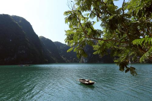 a small boat in the middle of a lake at Cat Ba Boat - Private Boat in Cat Ba