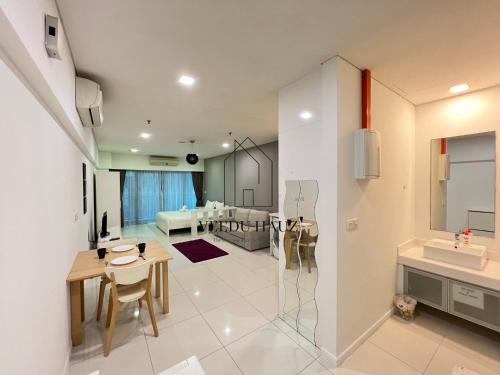 Il comprend une cuisine et un salon avec une table et un évier. dans l'établissement Mercu Summer Suites, à Kuala Lumpur