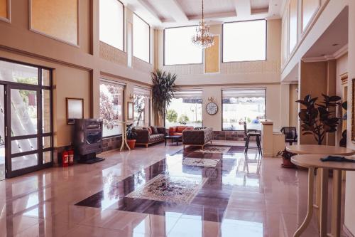 a large living room with windows and a lobby at Nafron Hotel in Prizren