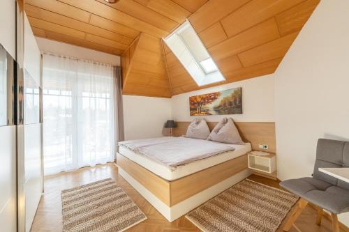 a small bedroom with a bed and a skylight at Ferienhaus Karoline in Lichtpold