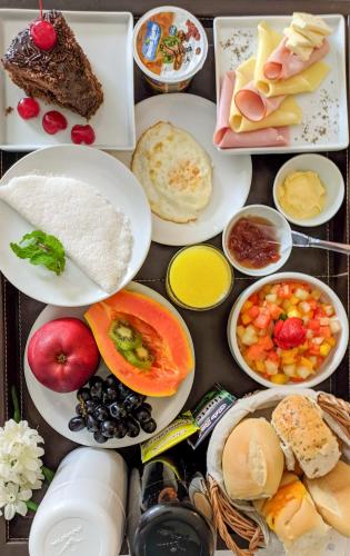 a table topped with plates of food and desserts at Reymar Hotel Maceió in Maceió