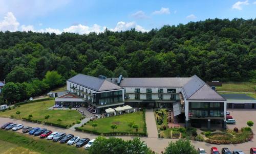 an aerial view of a large building with a parking lot at Castellum Hotel Hollókő in Hollókő