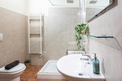 a bathroom with a sink and a toilet at Toscana Amore Mio, stunning view & 14min Volterra in Montecatini Val di Cecina