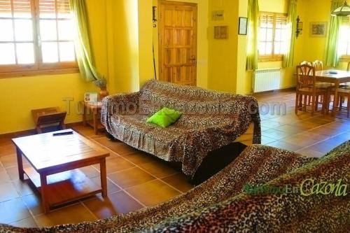 a living room with two couches and a table at CASA CAÑADA DEL PUERTO in Cazorla