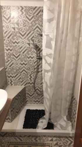 uma casa de banho com chuveiro e cortina de chuveiro em Camera Privata Orchidea em Castellero
